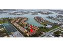 Overhead shot displays condo complex with landscaping and access to water at 406 Sandy Hook Rd, Treasure Island, FL 33706