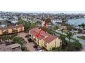 Aerial view shows condo complex in residential area with trees and waterway access at 406 Sandy Hook Rd, Treasure Island, FL 33706