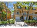 Charming townhome featuring a private garage, front balcony, and well-maintained landscaping at 5014 W Lancaster St, Tampa, FL 33616