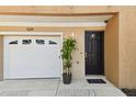 Welcoming front entrance featuring a one-car garage and a beautifully decorated front door at 5014 W Lancaster St, Tampa, FL 33616