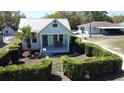 Aerial view of charming home surrounded by lush hedges, manicured lawn, and peaceful neighborhood at 5123 5Th St, Zephyrhills, FL 33542