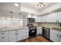 Stylish kitchen boasts stainless appliances, white cabinetry, granite counters and a view of the ocean at 5200 Brittany S Dr # 1503, St Petersburg, FL 33715