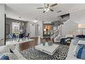 Open-concept living room and dining area with hardwood floors, modern decor, and staircase access at 555 52Nd N Ave, St Petersburg, FL 33703