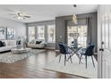 Bright living area featuring hardwood floors, modern furniture, and an adjacent dining space at 555 52Nd N Ave, St Petersburg, FL 33703
