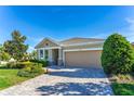 Beautifully landscaped single-story home with a well-manicured lawn and a two-car garage at 6002 Thrushwood Rd, Lithia, FL 33547