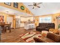 Open-concept living space with kitchen, dining, and sitting area under vaulted ceilings at 6262 142Nd N Ave # 904, Clearwater, FL 33760