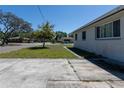 Side view of a house with a tree in the yard, sidewalk, and street at 801 37Th S Ave, St Petersburg, FL 33705