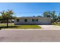 View of the back of a home with a garage and a dry, patchy yard at 801 37Th S Ave, St Petersburg, FL 33705