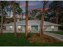 Charming single-story home with a bright turquoise front door, landscaped yard, and mature trees at 8693 15Th N St, St Petersburg, FL 33702