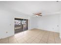 Bright living room with tile floors, ceiling fan and sliding glass doors that lead to a cozy balcony at 9031 Westchester Cir # 126, Tampa, FL 33604