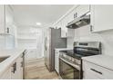 Bright kitchen featuring white cabinets, stainless steel appliances, and a modern design at 10201 N Ninevah Rd, Tampa, FL 33617