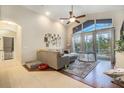 Bright living room with vaulted ceilings and large windows, bringing the outdoors in at 10623 Pearl Berry Loop, Land O Lakes, FL 34638