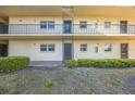 Exterior view of building featuring a courtyard with manicured shrubs along the base of the building at 11485 Oakhurst Rd # 111, Largo, FL 33774