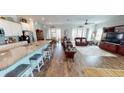 Open-concept floor plan showcasing the kitchen, dining, and living areas with hardwood floors at 12403 Brick Cobblestone Dr, Riverview, FL 33579