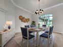 Elegant dining room showcasing a decorative chandelier, stylish furniture, and neutral colors at 1403 Crooked Stick Dr, Valrico, FL 33596