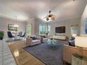 Well-appointed living room featuring stylish furniture, hardwood flooring, and lots of natural light at 1403 Crooked Stick Dr, Valrico, FL 33596