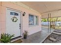 Close up on front porch, white door with decorative wreath at 164 Nw Lincoln N Cir, St Petersburg, FL 33702