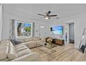 Bright and airy living room with stylish decor, hardwood floors, and a large window at 164 Nw Lincoln N Cir, St Petersburg, FL 33702