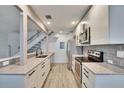 Well-lit kitchen with stainless steel appliances, granite countertops, and modern tile backsplash at 1832 Bough Ave # 3, Clearwater, FL 33760