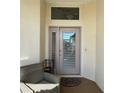 Inviting covered entryway with seating area and decorative accent window above the door at 2021 E Del Webb Blvd, Sun City Center, FL 33573
