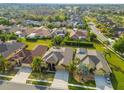 Beautiful aerial view of homes with well-manicured lawns and mature landscaping in a desirable neighborhood at 23523 Gracewood Cir, Land O Lakes, FL 34639