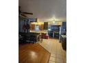 Open-concept kitchen featuring tile floors, dark wood cabinets, and rustic accents with views to the dining room at 26419 Rolling Acres E Dr, Brooksville, FL 34602