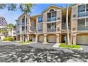 Charming condo complex with multiple units, garage parking, and manicured landscaping at 4204 Bay Club Cir, Tampa, FL 33607