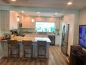 Bright, updated kitchen with stainless steel appliances, breakfast bar, and wood-look floors at 427 79Th Ave, St Pete Beach, FL 33706