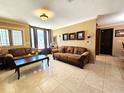 Comfortable living room showcasing tile floors, neutral paint, and a decorative stained-glass front door at 514 Brandon Ave, Clearwater, FL 33765