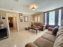 Inviting living room with tile flooring, neutral walls, and a stained glass front door at 514 Brandon Ave, Clearwater, FL 33765
