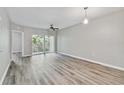 Well-lit living room with sliding glass doors leading to a balcony at 6447 Cypressdale Dr # 202, Riverview, FL 33578