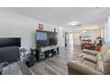 Open living space showcasing laminate flooring, neutral tones, and seamless flow to the dining area at 7143 Sealawn Dr, Spring Hill, FL 34606