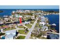 An aerial view of the single-story home with surrounding waterway views in a quaint neighborhood at 8077 Island Dr, Port Richey, FL 34668