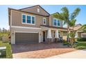 Charming two-story home with a brick paver driveway and well-manicured lawn at 8766 Capstone Ranch Dr, New Port Richey, FL 34655