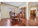 Elegant dining room featuring wood floors, a large window, and a classic wooden china cabinet at 10216 Moshie Ln, San Antonio, FL 33576