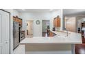 Bright kitchen features stainless steel appliances, light countertops, and ample cabinet space at 10216 Moshie Ln, San Antonio, FL 33576