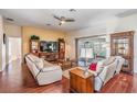 Comfortable living room showcasing wood floors, neutral walls, and a ceiling fan for added comfort at 10216 Moshie Ln, San Antonio, FL 33576