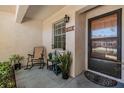 Inviting front porch featuring a rocking chair and a neatly decorated entrance with potted plants at 1159 Montrose Pl, Dunedin, FL 34698