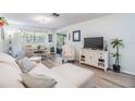 Bright living room featuring an abundance of natural light, modern furniture, and sleek flooring at 1159 Montrose Pl, Dunedin, FL 34698