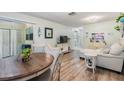 Open-concept living area with stylish furnishings, wood-look floors, and a seamless flow to the lanai at 1159 Montrose Pl, Dunedin, FL 34698
