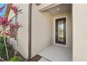 This home boasts a beautiful front door, complemented by attractive landscaping and exterior design at 13822 Carlow Park Dr, Riverview, FL 33579