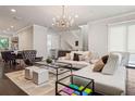 Elegant living room with a stylish chandelier, plush seating, and decorative area rug at 224 S Audubon Ave, Tampa, FL 33609