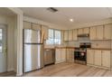 Well-lit kitchen boasts stainless steel appliances, wood countertops and ample cabinet space at 238 Pelican N Dr, Oldsmar, FL 34677