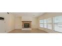 Spacious living room with a brick fireplace, plenty of natural light, and wood-look floors at 238 Pelican N Dr, Oldsmar, FL 34677
