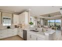 Modern kitchen with white cabinets, granite countertops, stainless steel appliances, and an open layout at 29548 Zupetta Ln, Wesley Chapel, FL 33543