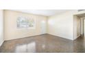 Bright Living Room Featuring Large Window, Neutral Paint, and Polished Concrete Flooring at 3005 E Sligh Ave, Tampa, FL 33610