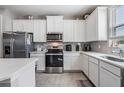 Well-lit modern kitchen featuring stainless steel appliances and ample cabinet space at 30903 Quail Caper Cir, San Antonio, FL 33576