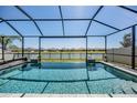 Sparkling pool with a screened enclosure and a view of the surrounding neighborhood at 31616 Parkland Bay Way, San Antonio, FL 33576