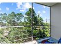 Screened-in patio offers stunning views of lush greenery and clear blue skies at 4210 Ironwood Cir # 501J, Bradenton, FL 34209