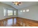 Bright, empty bedroom with laminated floors, vaulted ceilings, and an abundance of windows at 4702 Corsage Dr, Lutz, FL 33558